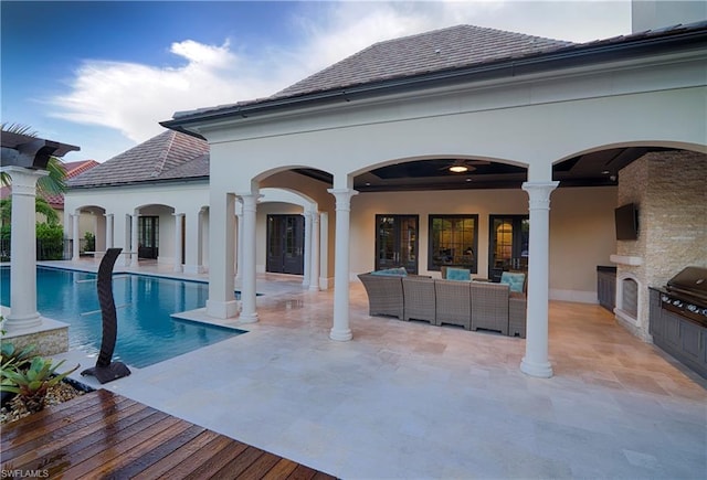 exterior space with a patio area, an outdoor kitchen, area for grilling, and an outdoor living space