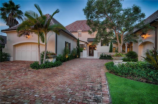 mediterranean / spanish house featuring a garage