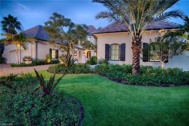 mediterranean / spanish house featuring a front yard