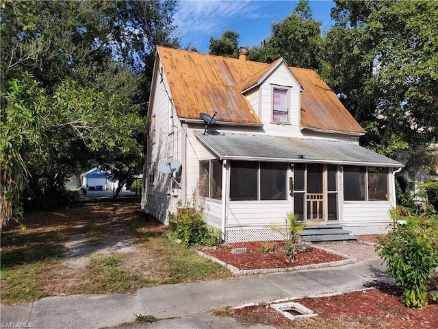 view of front of house with a sunroom