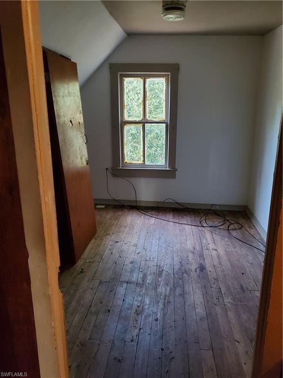 additional living space featuring lofted ceiling and hardwood / wood-style floors