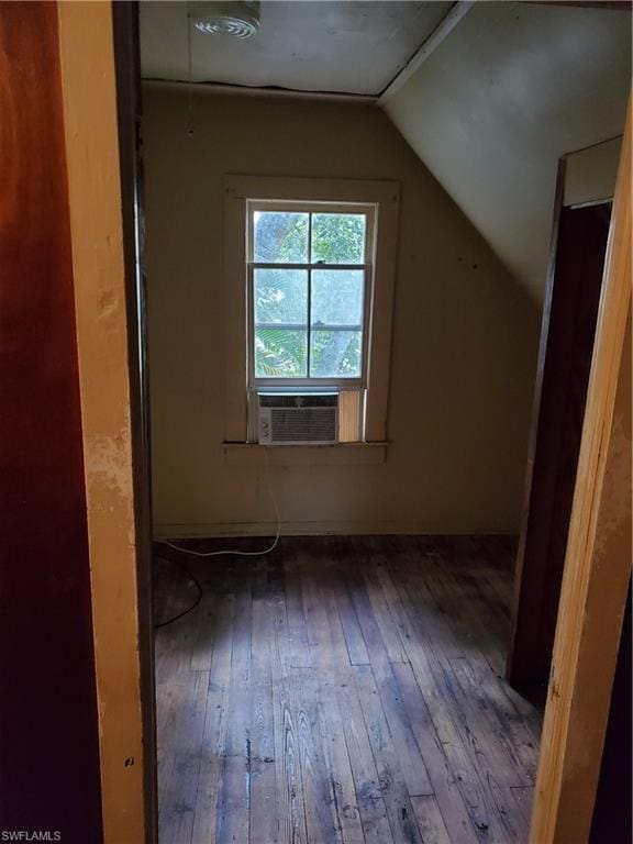 bonus room with wood-type flooring and vaulted ceiling