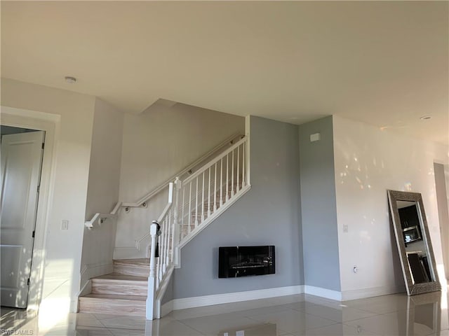 staircase with light tile floors