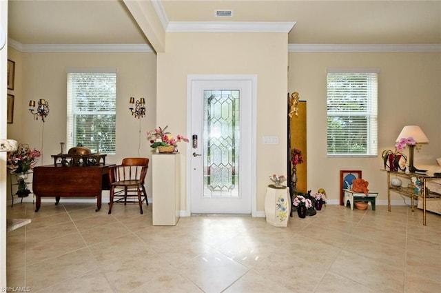 entrance foyer featuring crown molding and light tile flooring