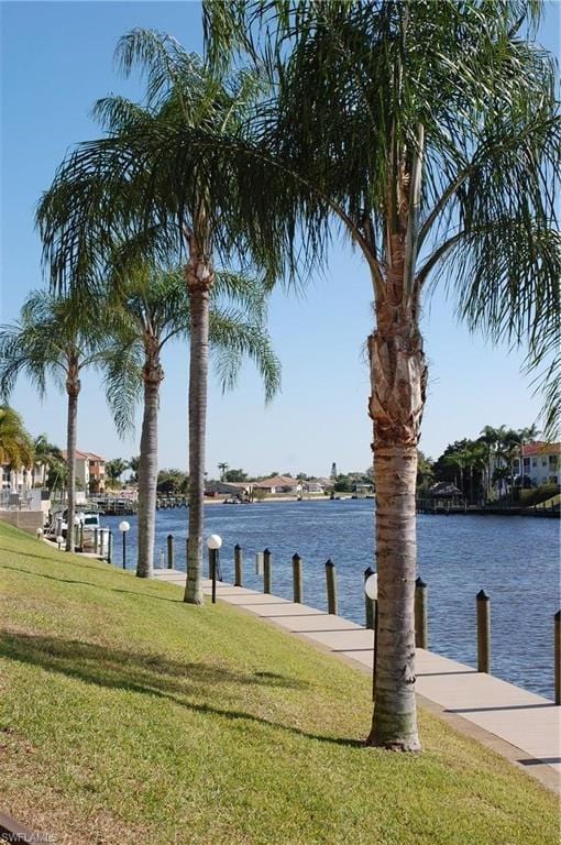 exterior space featuring a water view and a lawn