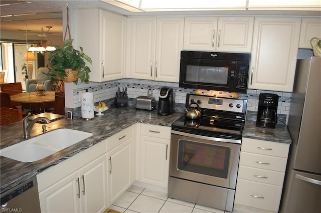 kitchen featuring white cabinetry, backsplash, sink, stainless steel appliances, and a chandelier