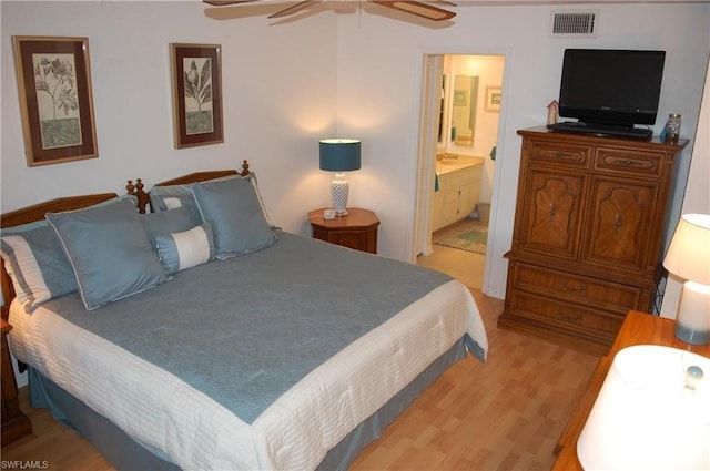 bedroom featuring ensuite bathroom, ceiling fan, and light hardwood / wood-style flooring