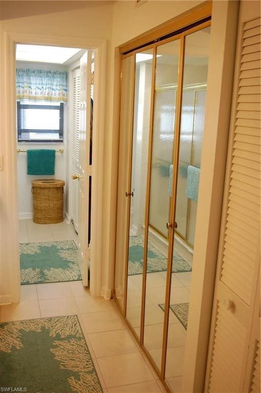 hallway with light tile floors and french doors