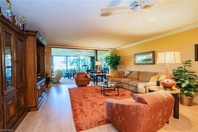 living room with floor to ceiling windows, light hardwood / wood-style floors, crown molding, and ceiling fan