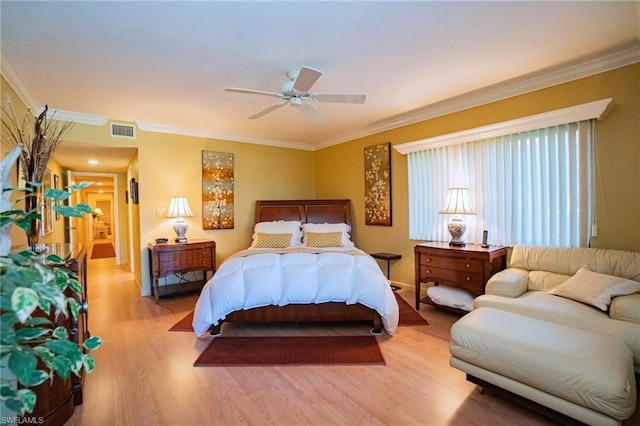 bedroom featuring ornamental molding, ceiling fan, and light hardwood / wood-style flooring