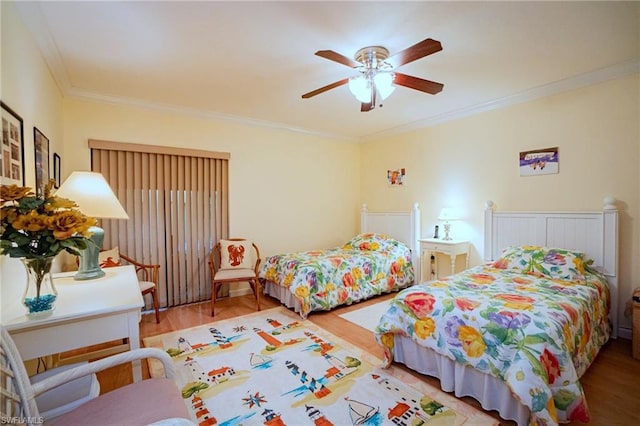 bedroom with light hardwood / wood-style floors, ceiling fan, and ornamental molding