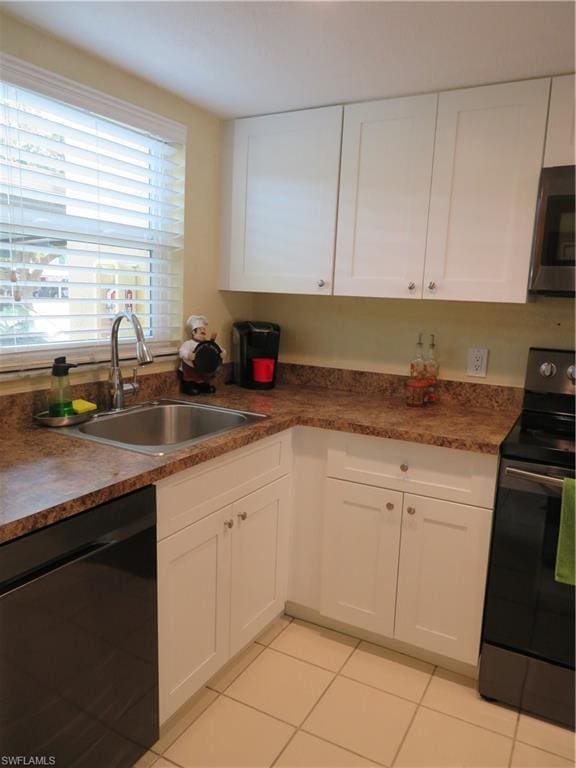 kitchen with white cabinets, light tile floors, appliances with stainless steel finishes, and sink