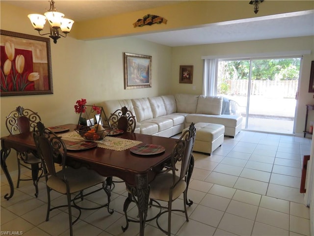 dining space featuring an inviting chandelier and light tile floors