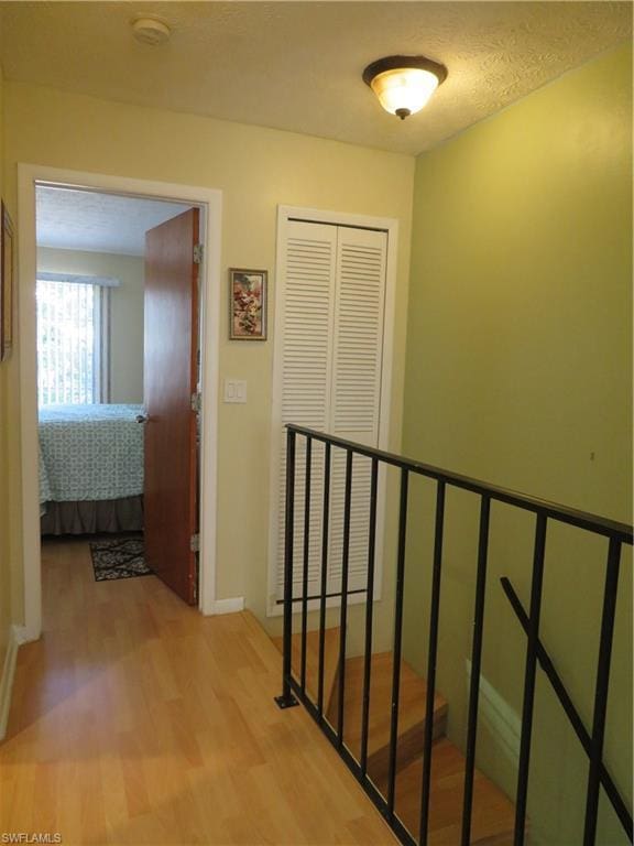 hallway with light hardwood / wood-style floors