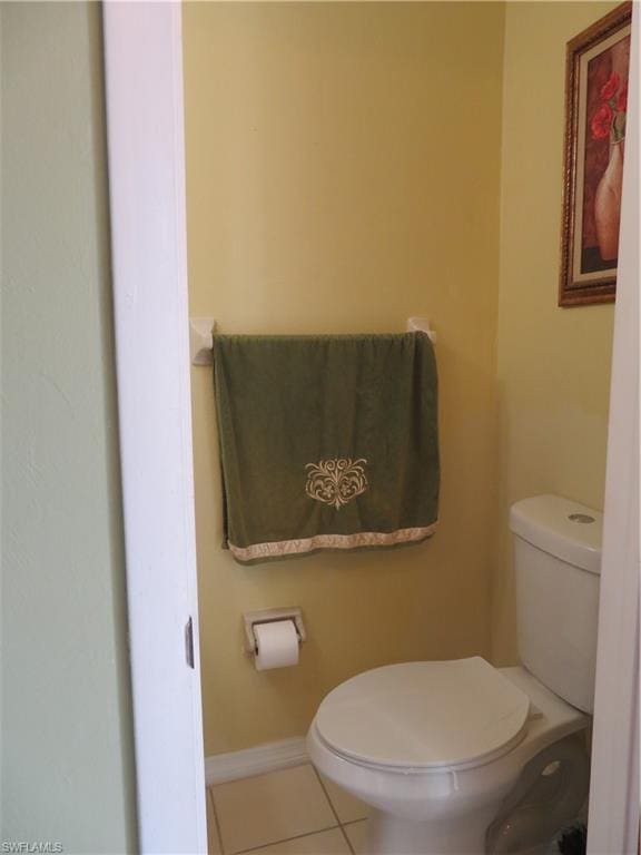 bathroom featuring toilet and tile floors