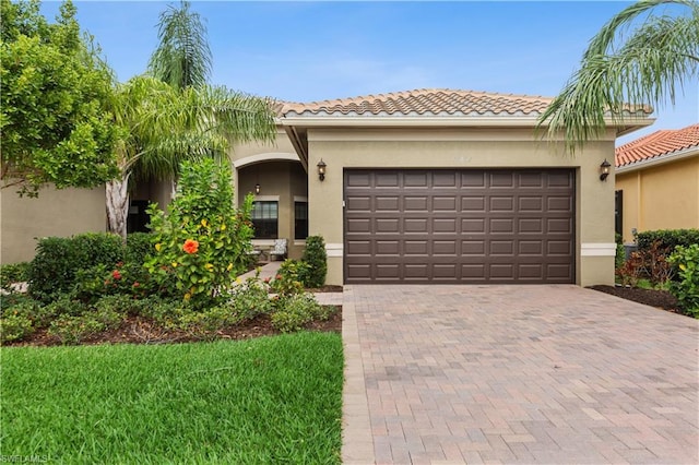 mediterranean / spanish-style home with a front lawn and a garage