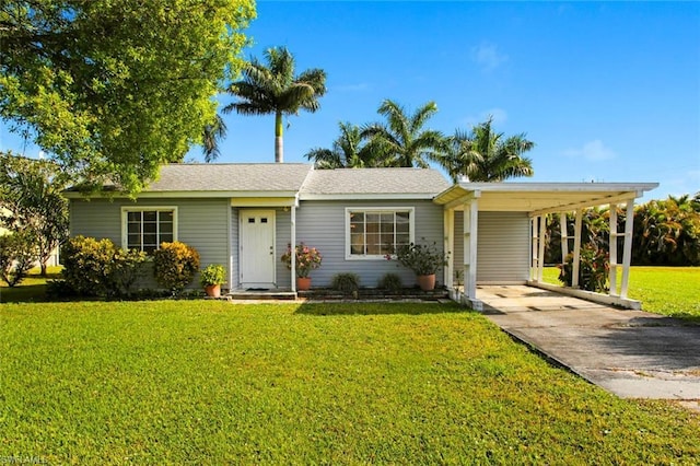 ranch-style home featuring a front yard and a carport