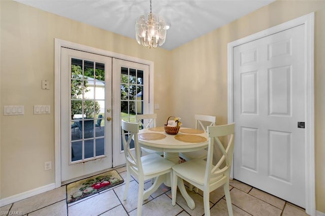 dining space with a notable chandelier, french doors, and light tile flooring