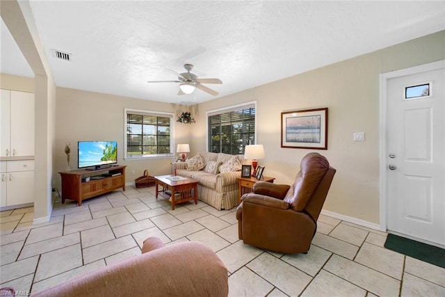 tiled living room with ceiling fan