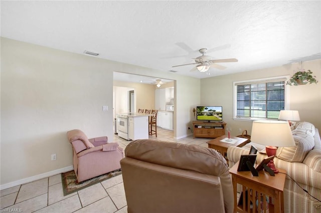 tiled living room featuring ceiling fan