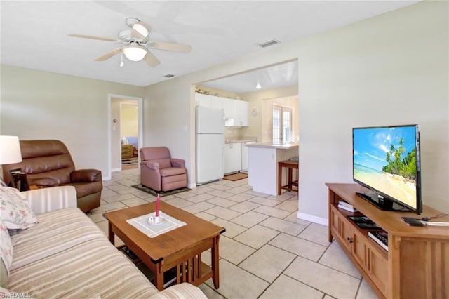 living room with light tile floors and ceiling fan