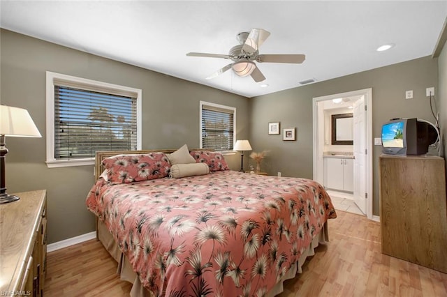 bedroom featuring light hardwood / wood-style floors, connected bathroom, and ceiling fan