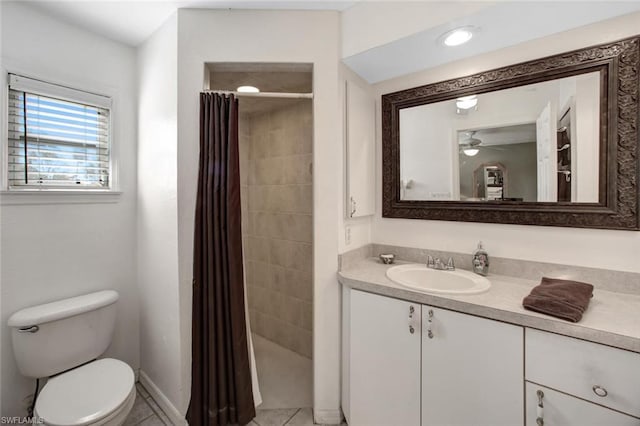 bathroom featuring tile floors, toilet, vanity, and ceiling fan