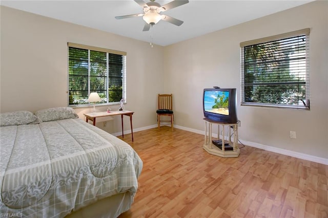 bedroom with ceiling fan and light hardwood / wood-style flooring