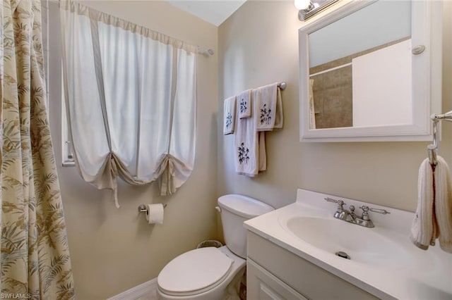 bathroom with toilet and vanity