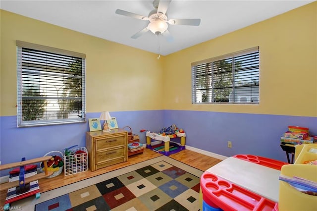 rec room featuring ceiling fan and light hardwood / wood-style flooring