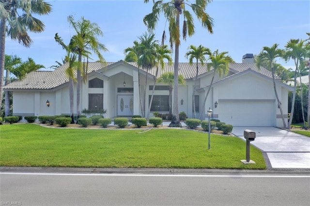 view of front of house featuring a front yard and a garage