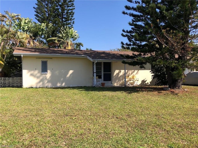 rear view of house with a lawn