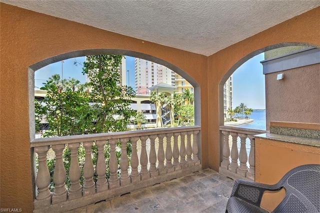 balcony featuring a water view