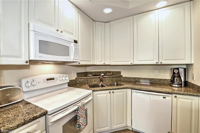 kitchen featuring white appliances, white cabinetry, and sink