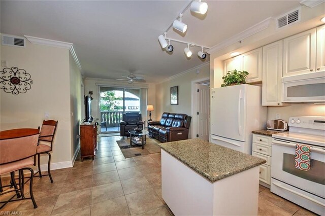 kitchen featuring white appliances, rail lighting, ceiling fan, and light tile floors