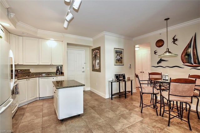 kitchen with a center island, decorative light fixtures, rail lighting, white appliances, and white cabinetry