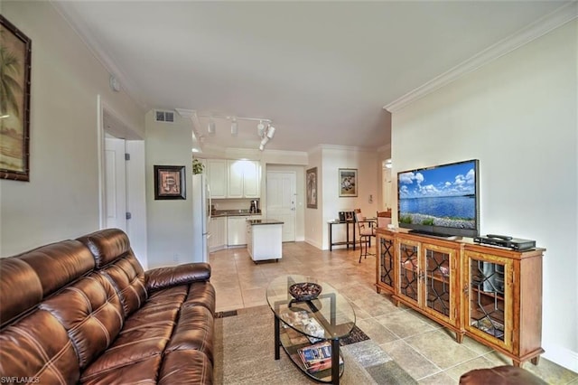 living room with crown molding and light tile flooring