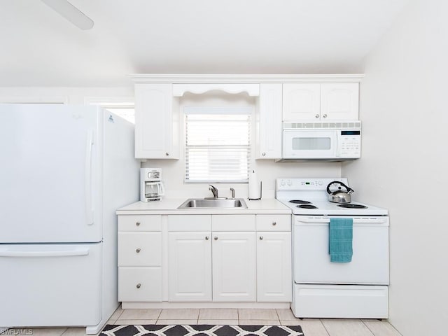 kitchen with white appliances, white cabinetry, sink, and light tile flooring