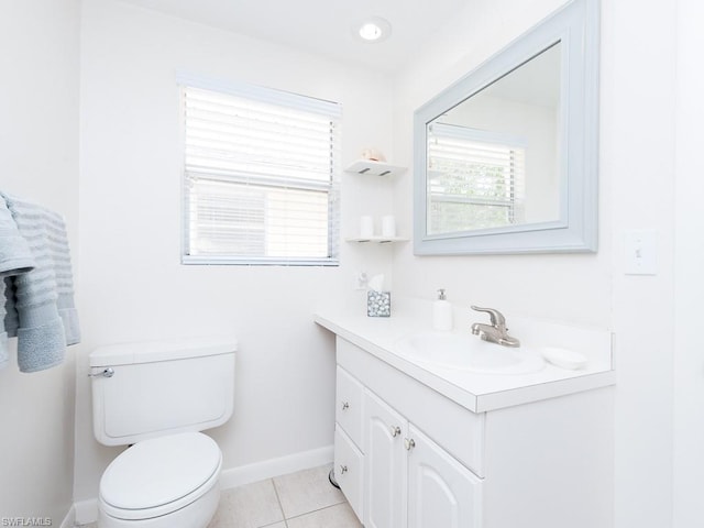 bathroom featuring toilet, vanity with extensive cabinet space, and tile flooring