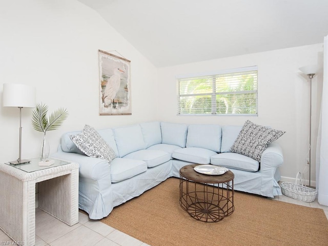 living room with lofted ceiling and light tile flooring