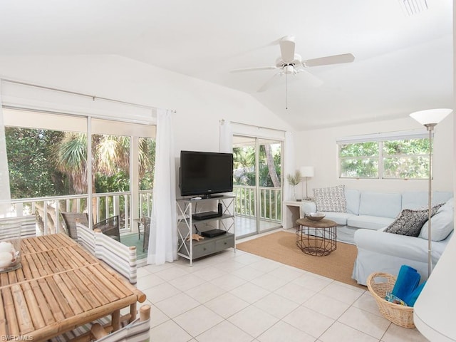 living room featuring light tile floors, lofted ceiling, and ceiling fan