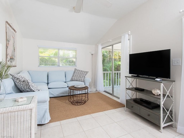 living room featuring ceiling fan, light tile floors, and lofted ceiling