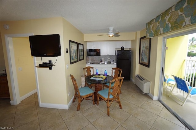 tiled dining space featuring ceiling fan