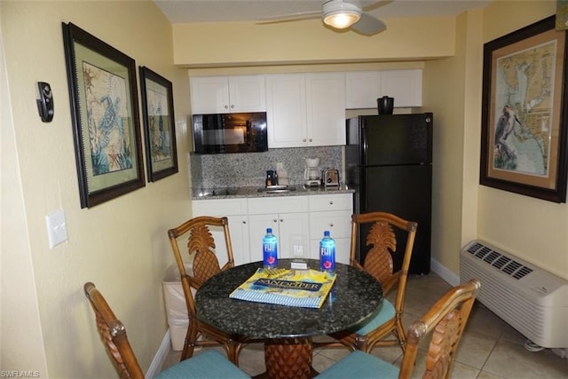 kitchen featuring white cabinets, backsplash, and black appliances