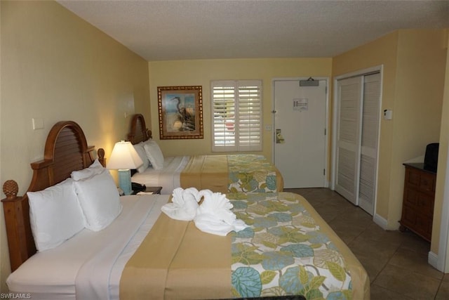 tiled bedroom featuring a closet