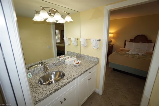 bathroom with oversized vanity, a chandelier, and tile flooring