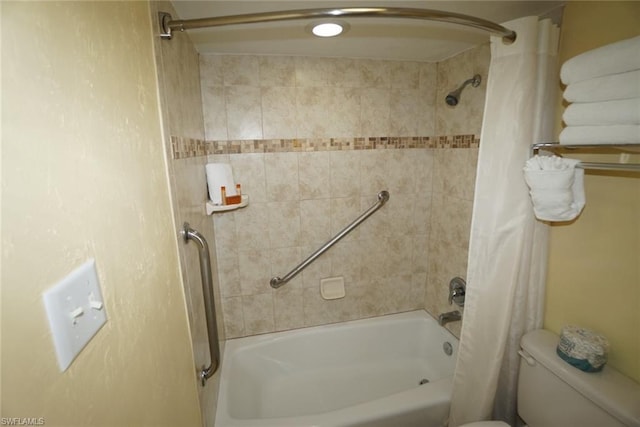 bathroom with shower / tub combo with curtain and toilet