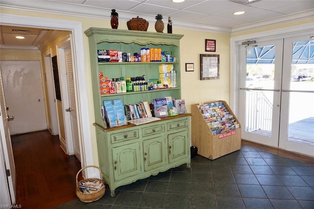 interior space featuring dark tile floors, crown molding, and french doors