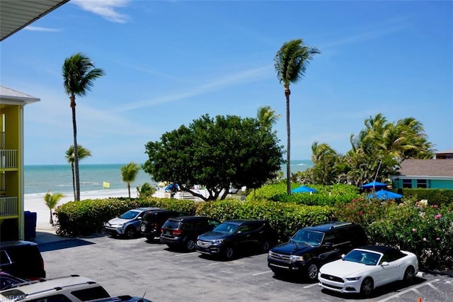 view of car parking with a water view