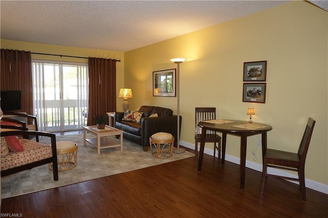 living room with a textured ceiling and light hardwood / wood-style flooring